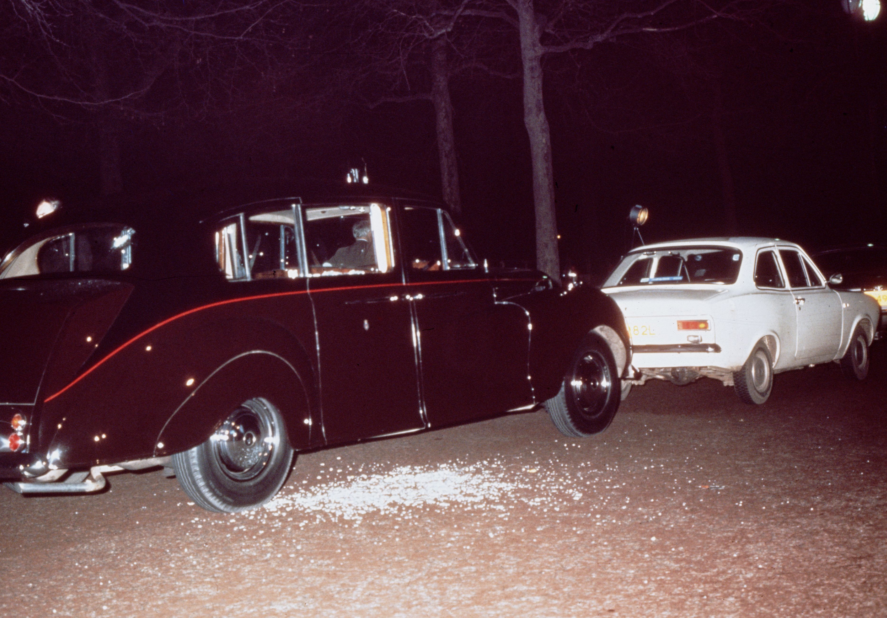 The aftermath of Ian Ball's attempt to kidnap Princess Anne, on The Mall, London, 20th March 1974. Ball's white Ford Escort is parked blocking the path of the Princess's Princess IV limousine