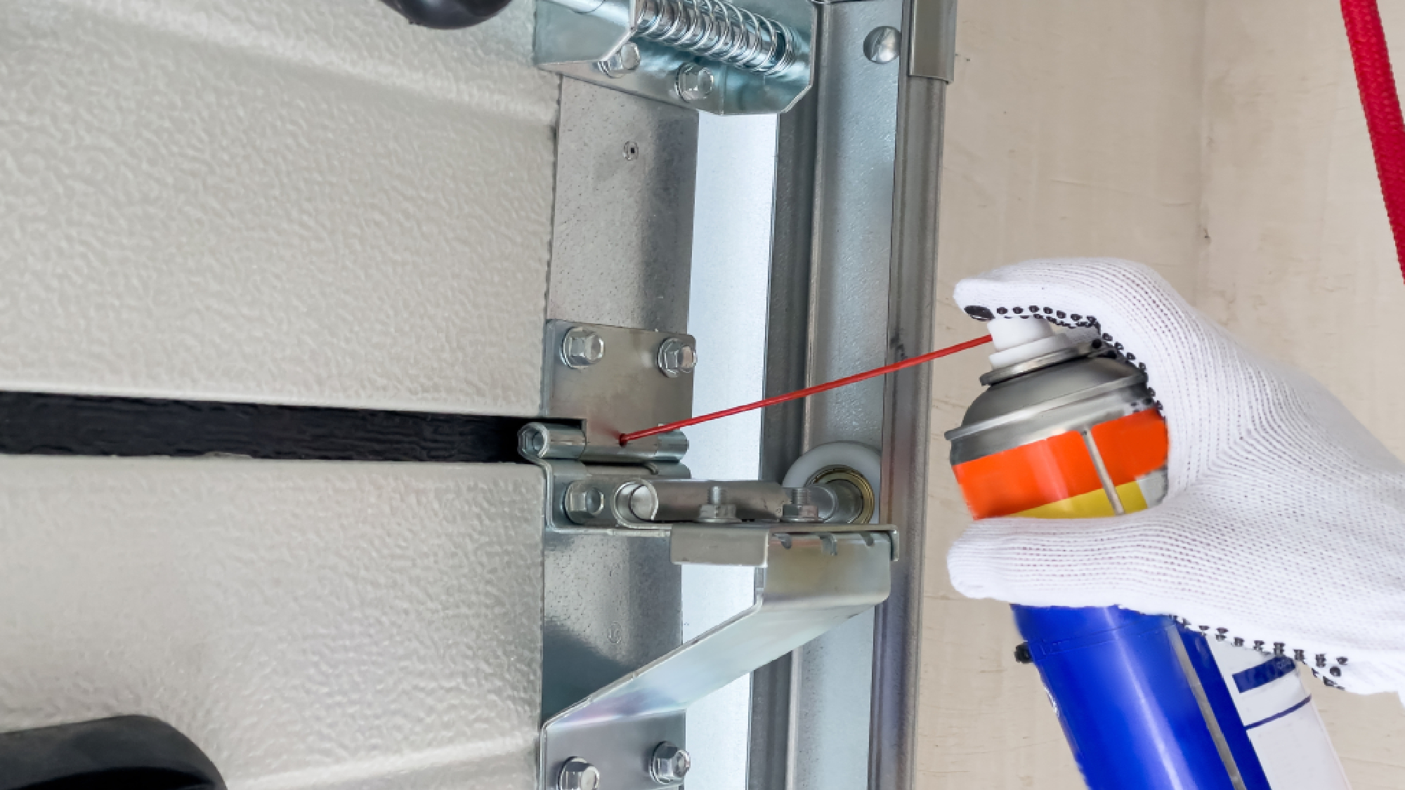 WD-40 being used on garage door