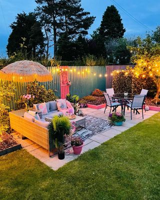 An outdoor backyard patio with string lights and outdoor furniture