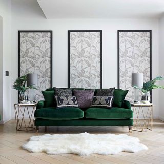 room with white wall and green sofa
