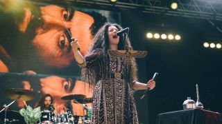 Nina Saeidi with a sword on stage