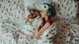 Woman and dog in bed