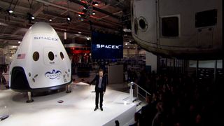 Elon Musk unveils the Dragon V2 space capsule on May 29, 2014, during a press briefing at the SpaceX headquarters in Hawthorne, California.