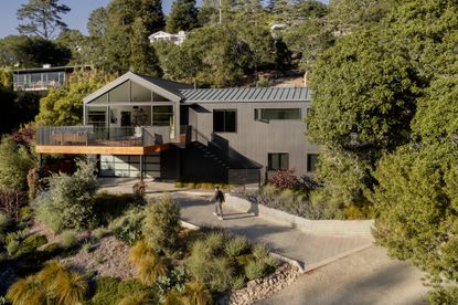 hero exterior of mill valley house with man walking towards it