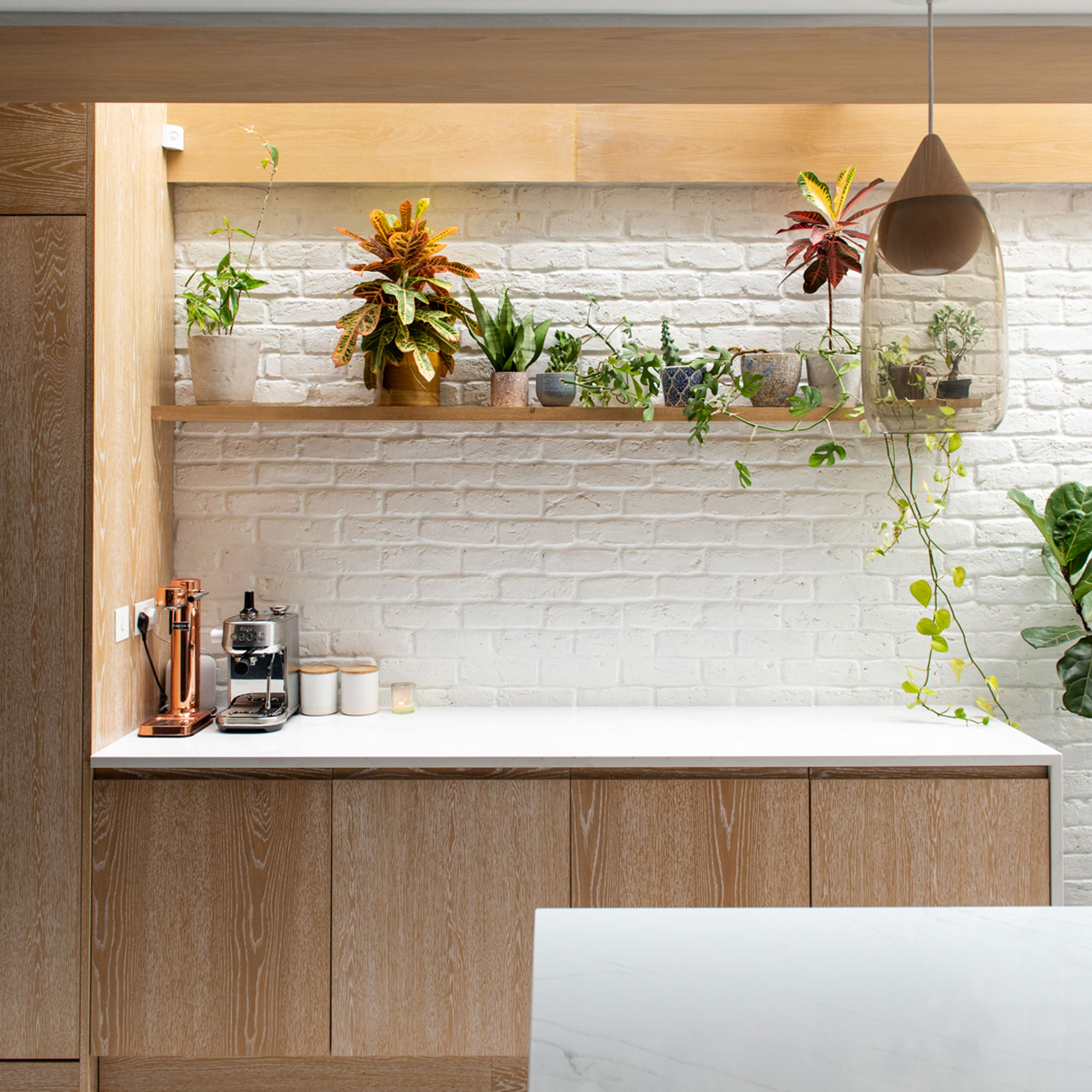 wooden kitchen with light from above through glass roof window