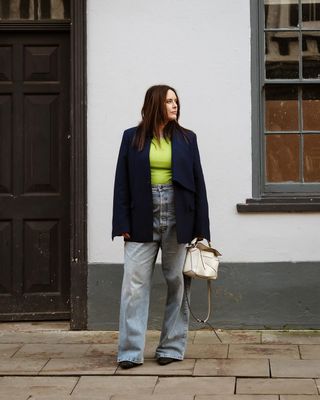 @annacascarina wearing straight fit jeans, lime top and blazer