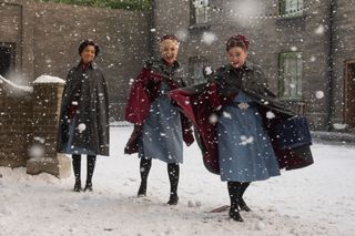 Nurse Lucille Anderson (LEONI ELLIOTT), Nurse Trixie Franklin (HELEN GEORGE), Nurse Nancy Corrigan (MEGAN CUSACK) have a snowball fight in Call the Midwife Christmas 2022