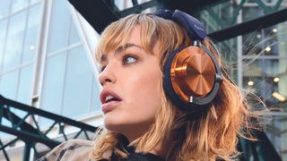 Woman wearing Dyson OnTrac headphones.