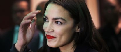 U.S. Rep. Alexandria Ocasio-Cortez (D-NY) wears red lipstick and prepares to speak at the National Action Network's annual convention