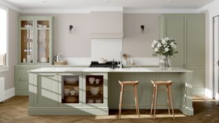 kitchen with sage green kitchen cabinets and off white walls and worktop