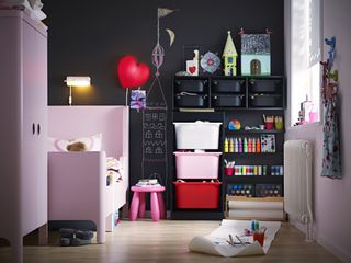 Kids storage furniture and pink bed and wardrobe with black chalkboard wall