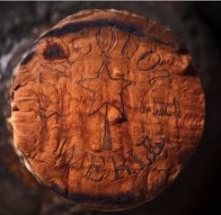 Cork from one of the ancient Champagne bottles, showing its maker.