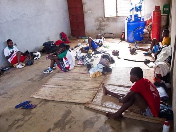 Coach Gandaho talks with the team in the room that served as a base for the Benin Team. The team slept on straw mats each night during the camp