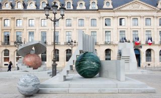 sculpture of concrete blocks and colourful sphere