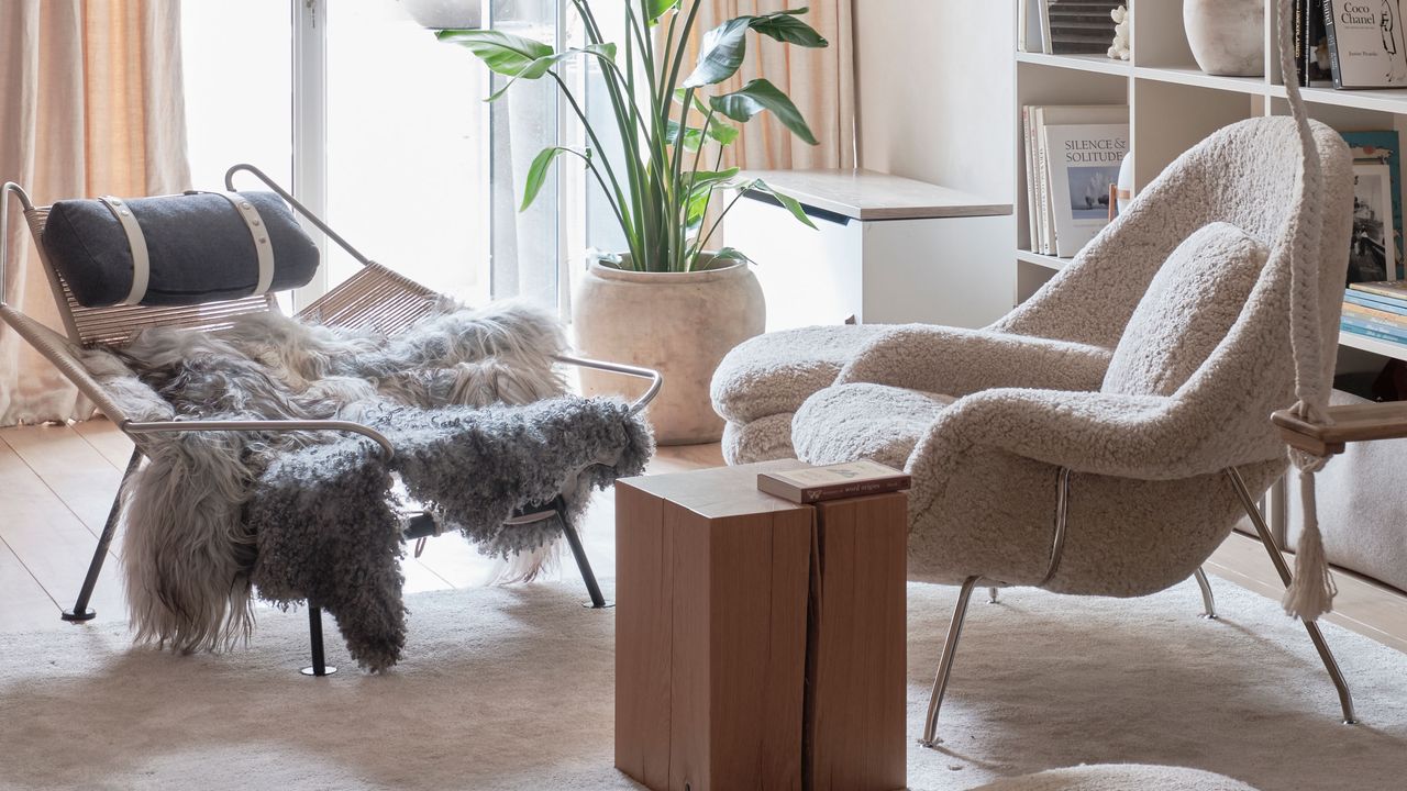 a sheepskin rug on a low chair and a boucle accent chair