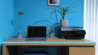 Twinkly Line smart lights on edge of desk, lit in green and blue gradient