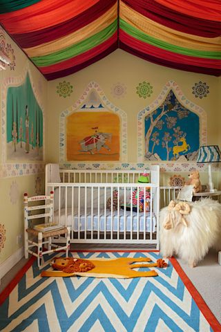 Nursery with multicolor fabric on ceiling