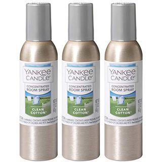 Three bronze spray bottles with grey lids, Yankee candle Clean Cotton labels on the front. 