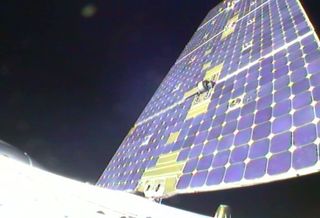 View from SpaceX's Dragon spacecraft looking outward at one of two solar array panels in the process of deploying after launch on May 22, 2012.