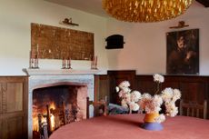 Fig 2: The intimate smaller dining room, in the older part of the house, is illuminated by a sculptural Carlo Scarpa chandelier and retains its original wood-panelling. Walcot, Oxfordshire — Photograph by Hugo Rittson Thomas Walcot, Oxfordshire — Photograph by Hugo Rittson Thomas