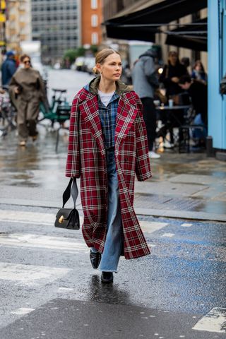 showgoer wearing plaid coat, plaid shirt, and jeans