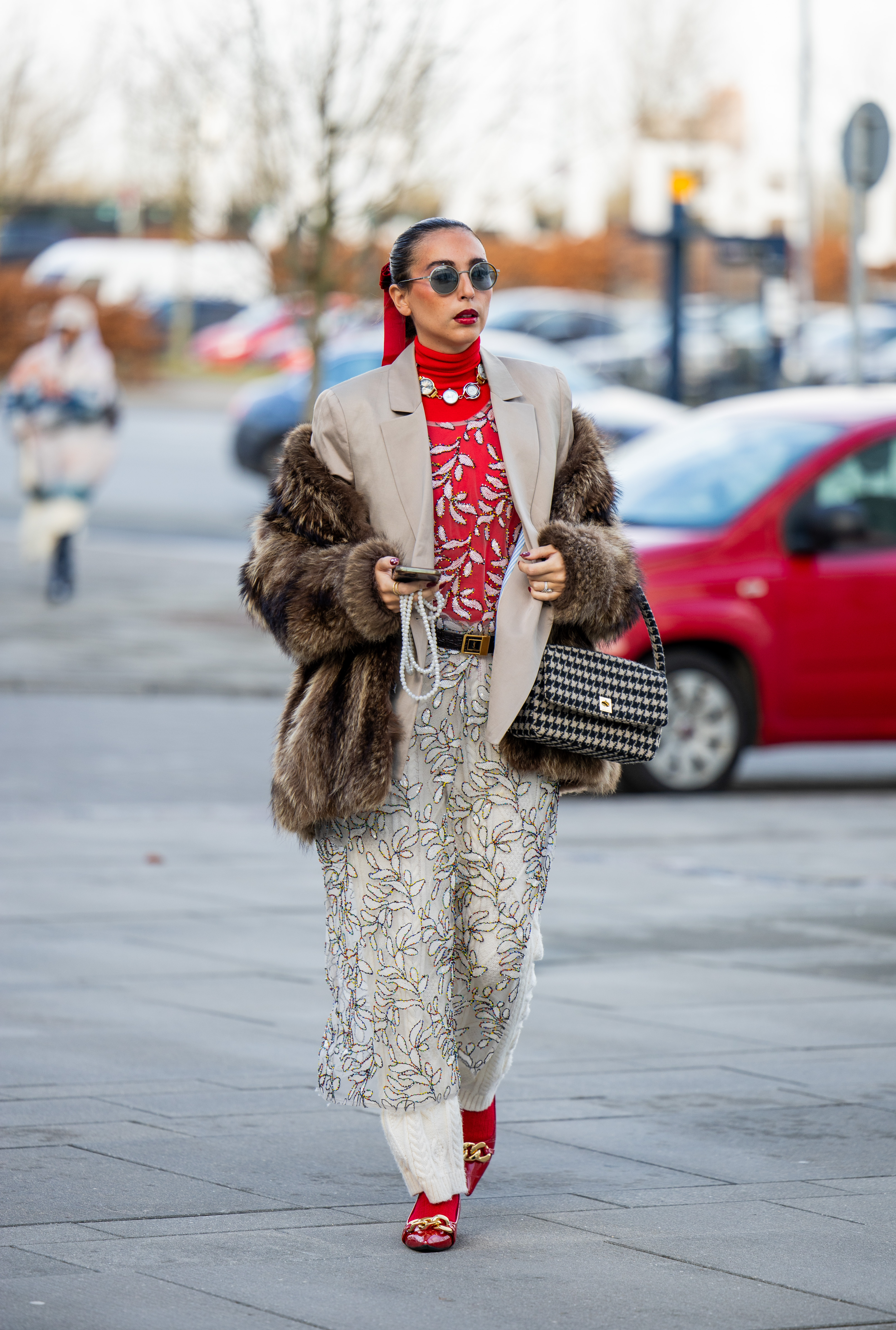 A model channeled Jennifer's skirt over pants hack during Copenhagen Fashion Week