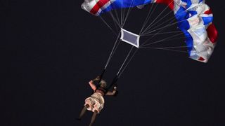 An actor dressed to resemble Britain's Queen Elizabeth II parachutes into the stadium during the opening ceremony of the London 2012 Olympic Games at the Olympic Stadium in London on July 27, 2012