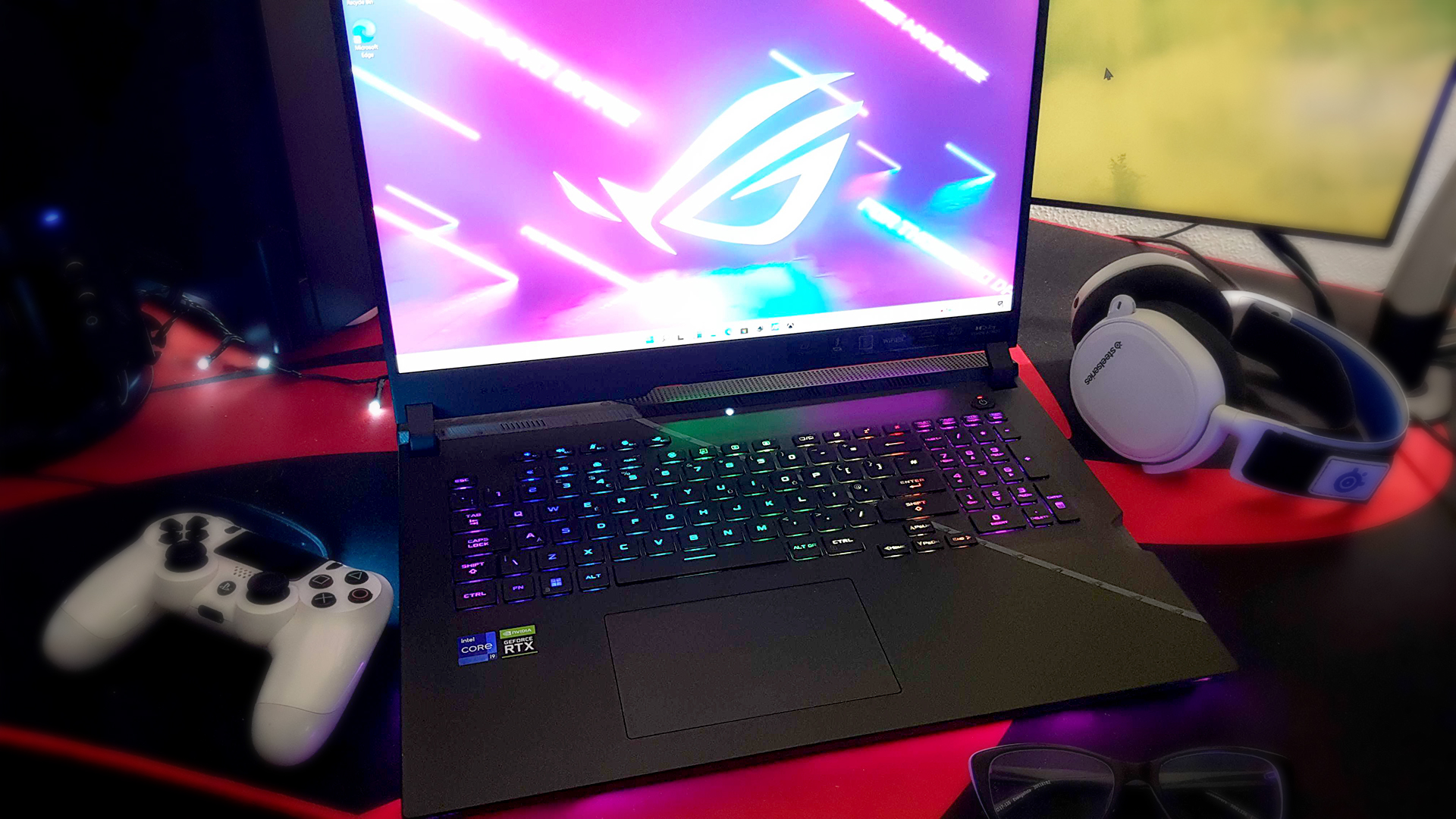 The Asus ROG Strix Scar 17 (2022) from the front, on a desk with some peripherals.