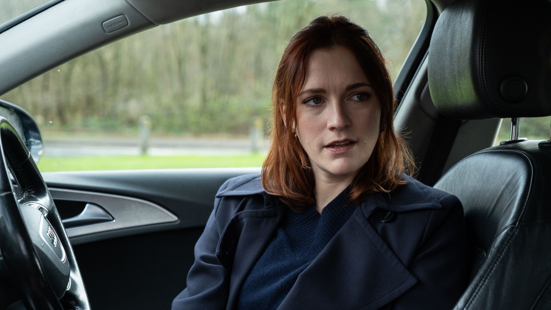 Ashleigh sits in a car in Code of Silence