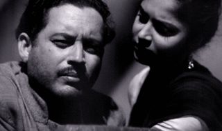 still from the classic bollywood movie pyaasa of a man and woman in black and white