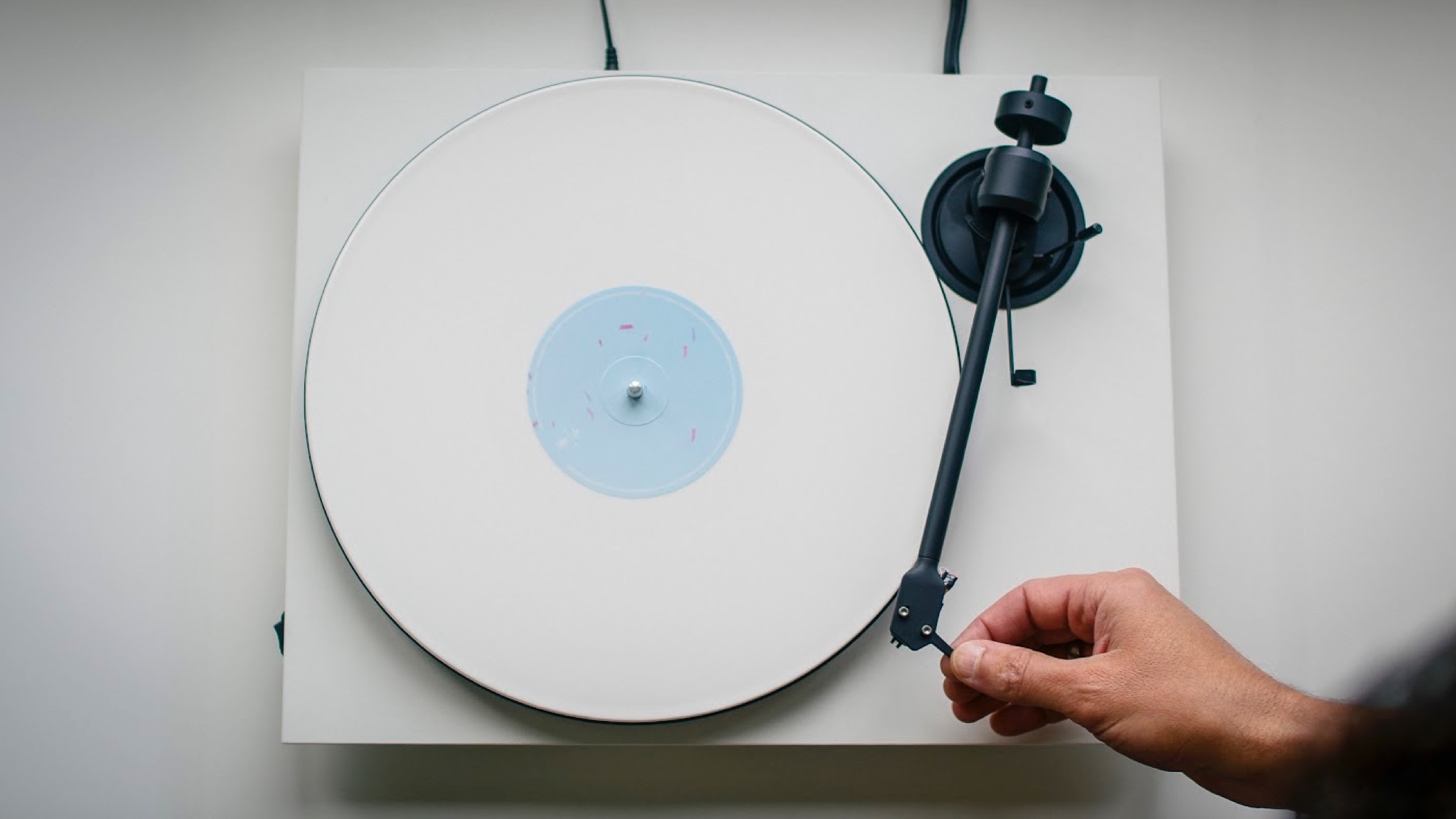 A top down view of the Pro-Ject E1.2 turntable on a white surface