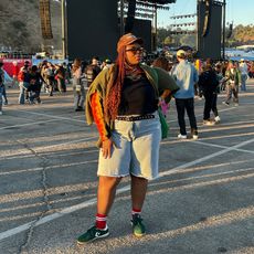 chichi wears denim shorts, long sleeve top, green cardigan, green converse run star trainers with red socks at camp flog gnaw