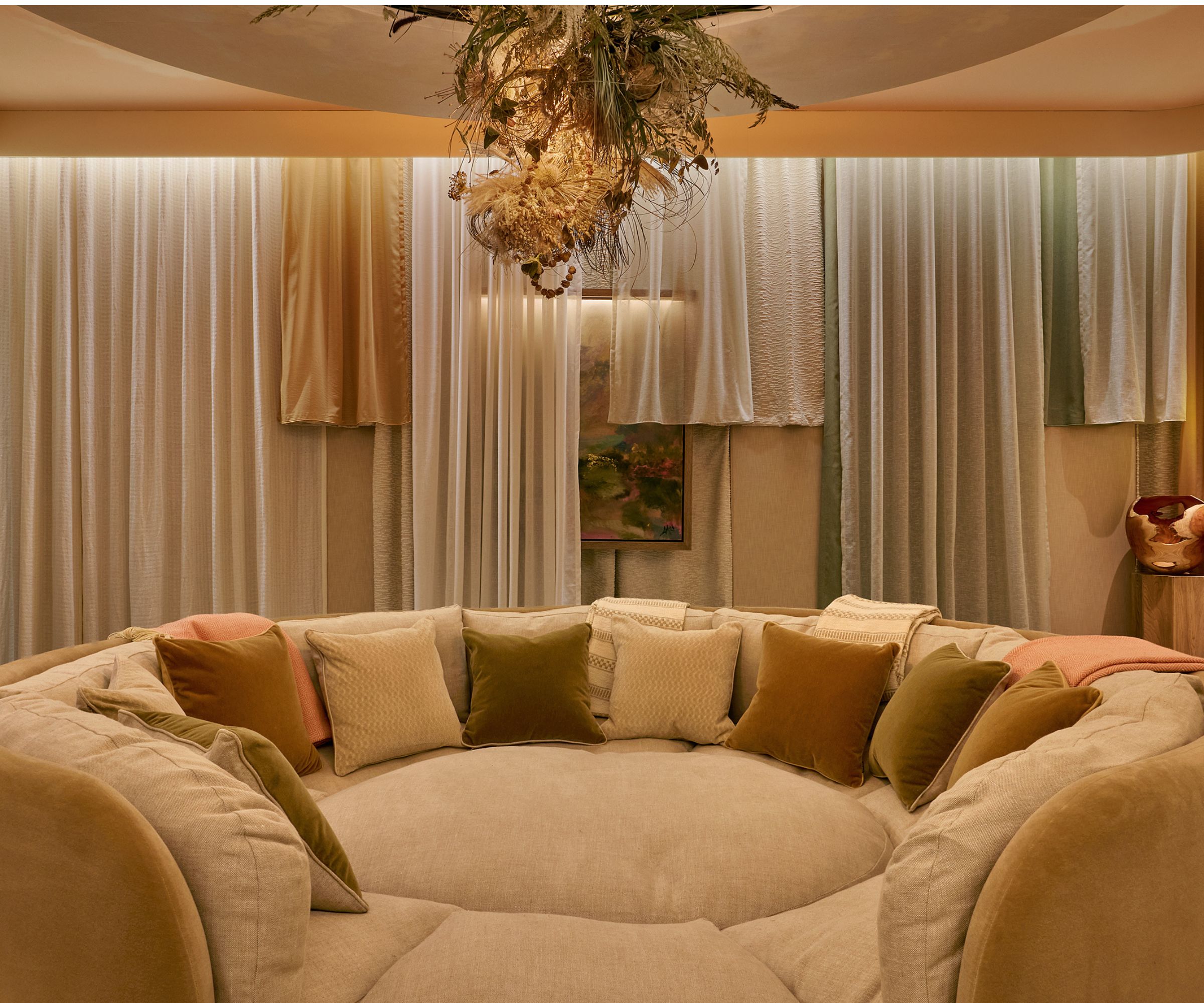 the 'nucleus' room at WOW!House 2026 featuring a giant dog bed style couch with draped walls and ceiling installation