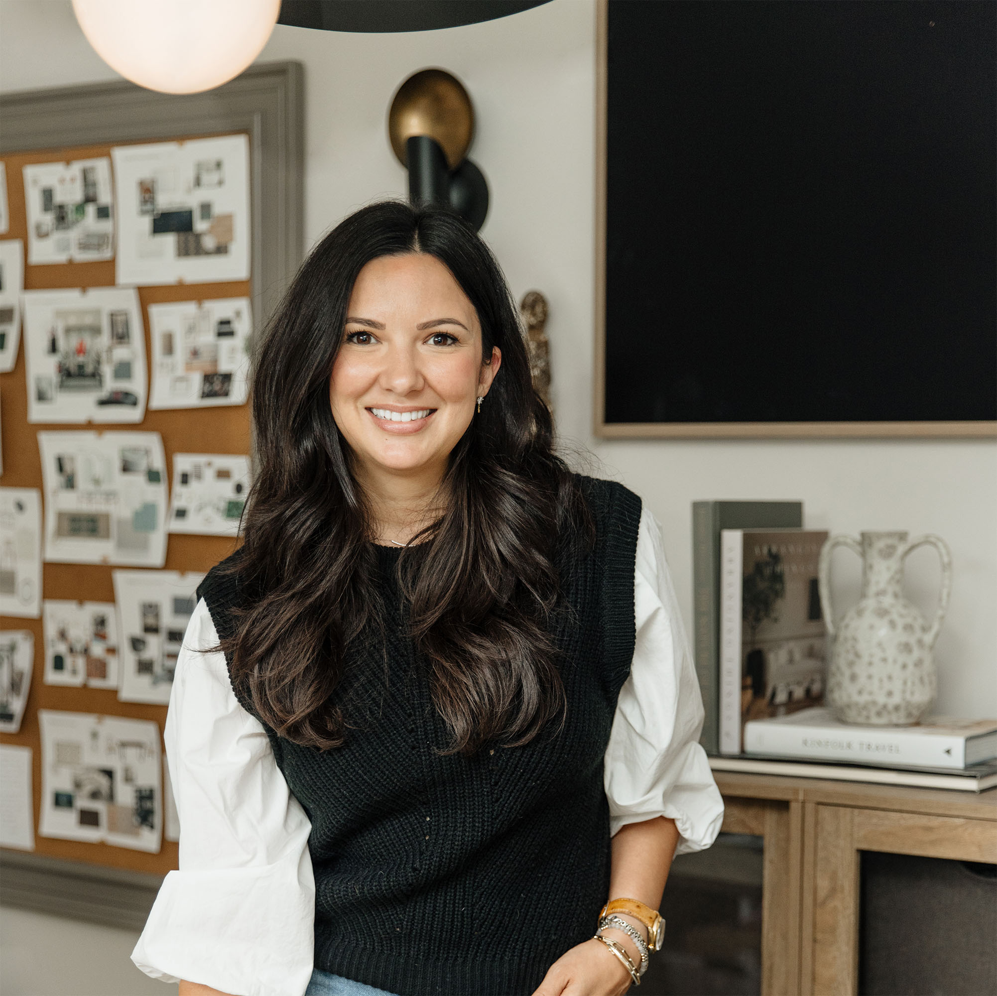 White woman with dark brown hair smiling in home space is Laura Chappetto @ElementDesignNetwork