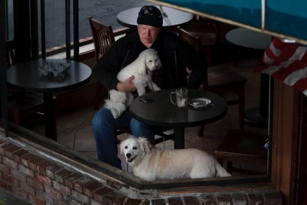 A man and his dogs takes a time out in a cafe on the race course in Auburn.