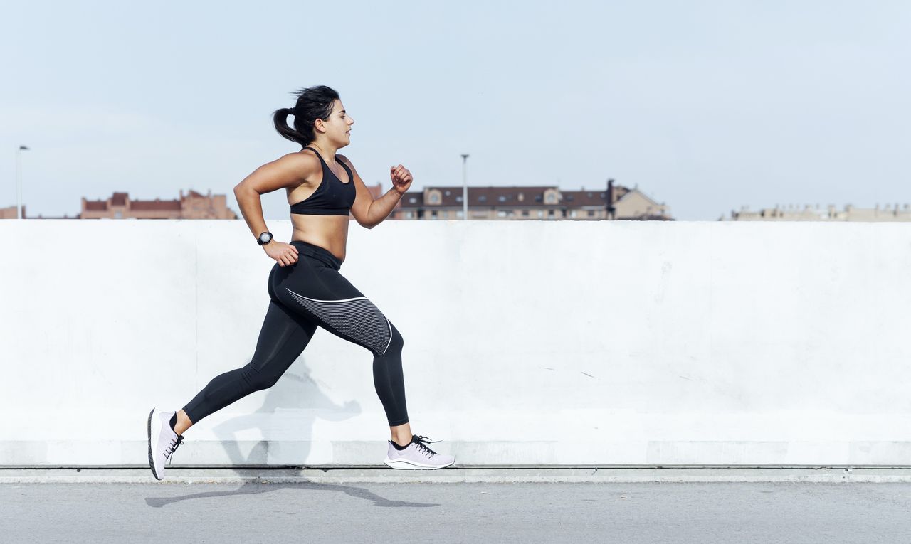 Woman running to get fit in sunshine