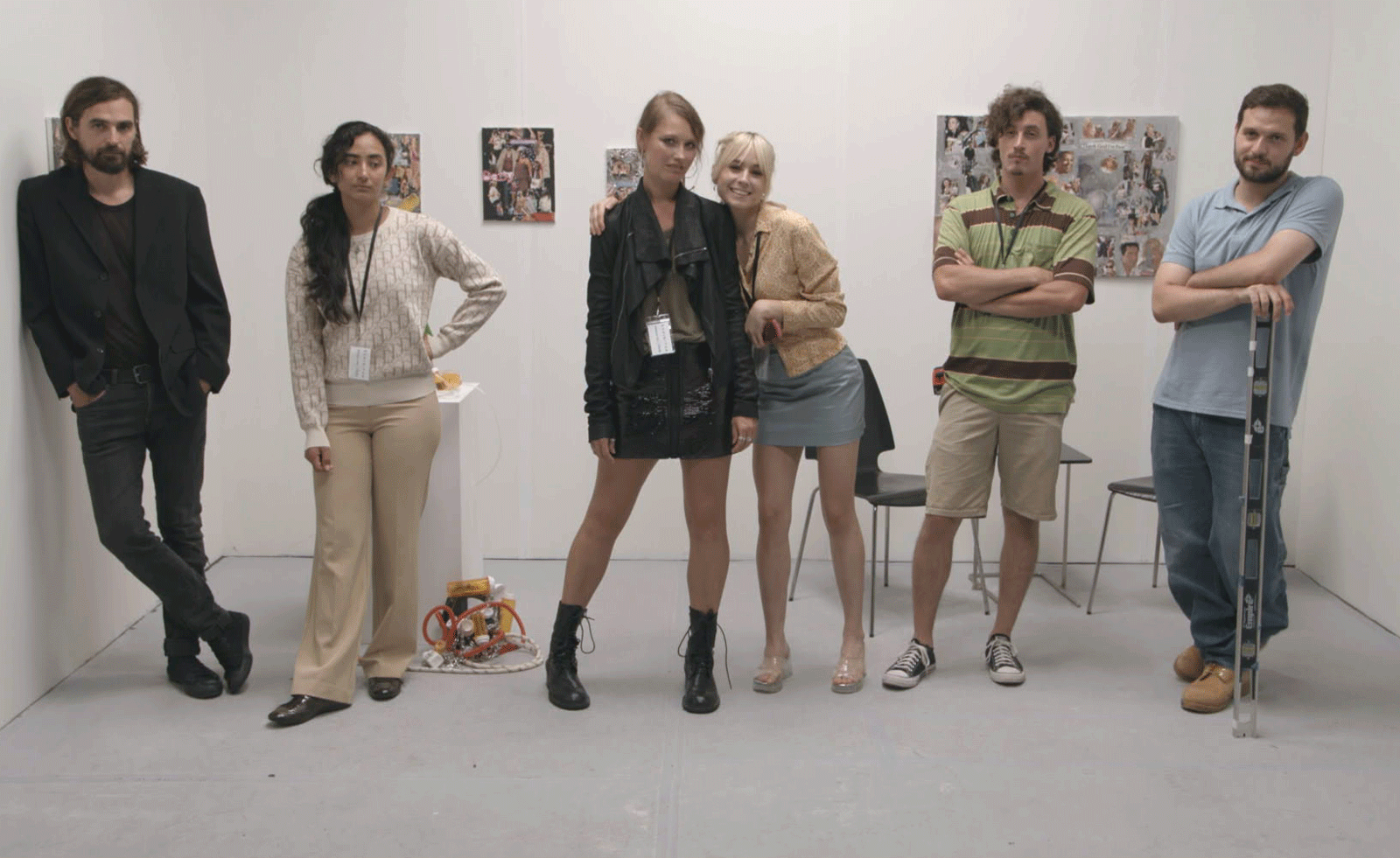 people stood in a row at an art gallery in a film still from artist Jenna Bliss&rsquo; True Entertainment, 2023