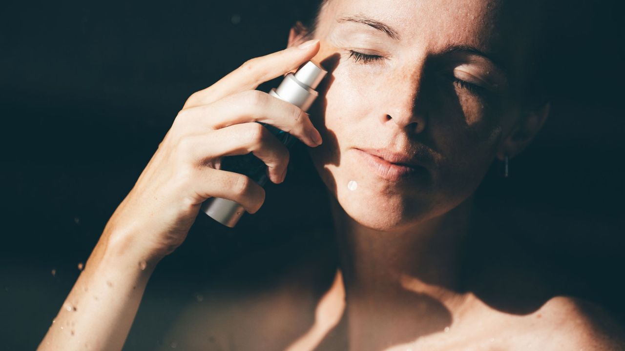 Woman applying a science-led skincare product