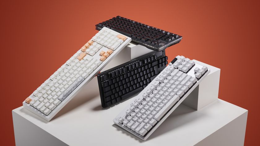 Selection of gaming keyboards on a white plinth with an orange background