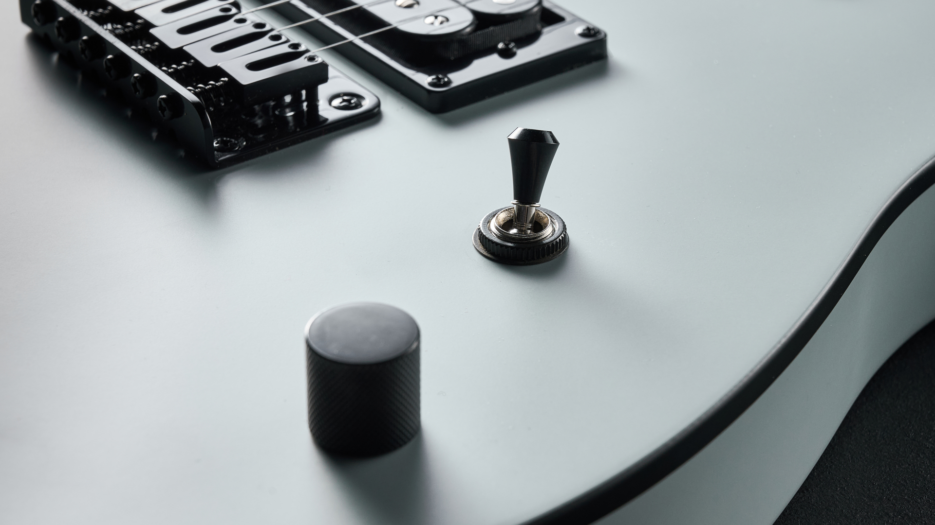 Close up of the master volume knob and toggle switch on the Charvel Standard Series San Dimas Style 2 SD2 HH HT electric guitar
