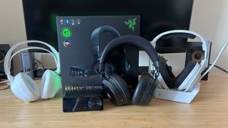 Razer Kraken V4 Pro (center) with packaging and OLED control hub, flanked by SteelSeries Arctis Nova Pro Wireless and Logitech Astro A50 X headsets