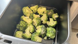 Broccoli in air fryer basket