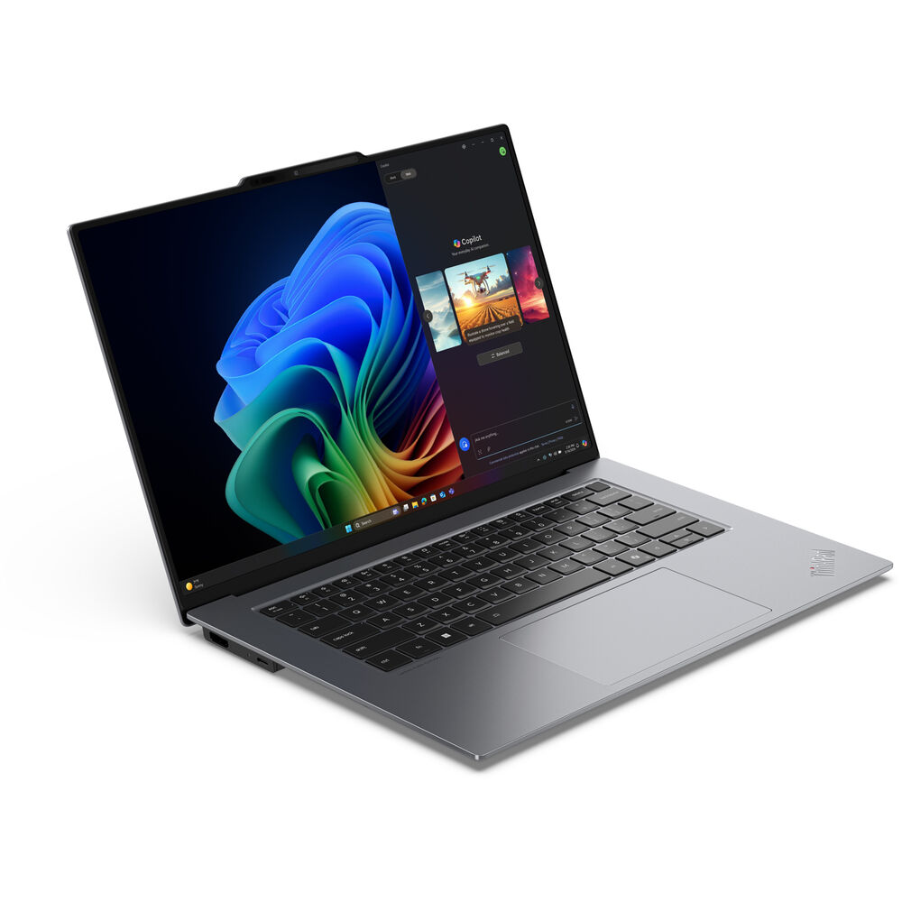 An angled view of an open and powered on laptop against a white background