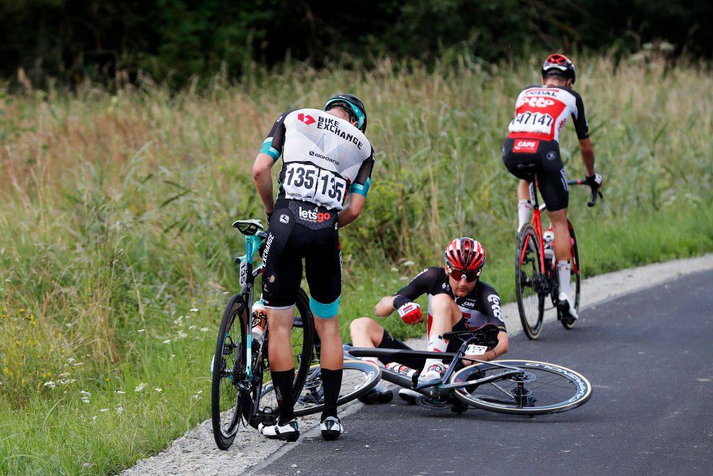 RZESZOW POLAND AUGUST 11 LR Barnabs Pek of Hungary and Team BikeExchange Tim Wellens of Belgium and Team Lotto Soudal involved in a crash during the 78th Tour de Pologne 2021 Stage 3 a 226km stage from Sanok to Rzeszw TourdePologne TDP2021 UCIWT on August 11 2021 in Rzeszow Poland Photo by Bas CzerwinskiGetty Images