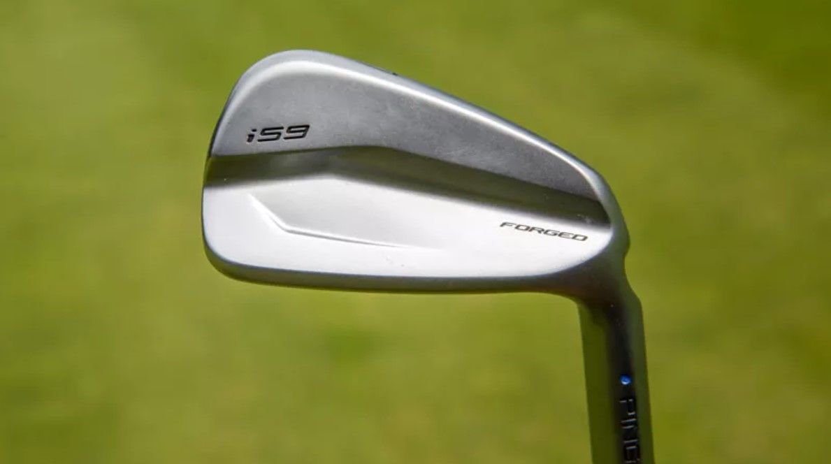 A ping i59 iron on a green background