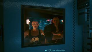 Cyberpunk 2077 screenshot of a photo of V and Jackie in a SmarFrame display in V's apartment