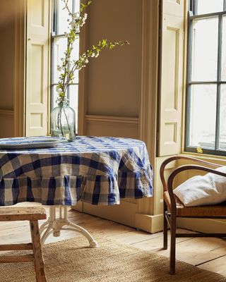 A blue and white checkerboard tablecloth against a yellow room