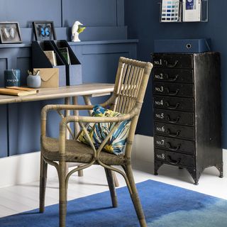 blue panel wall with drawers desk and chair