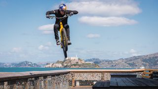 Danny MacAskill riding his mountain bike in San Francisco with Alcatraz in background