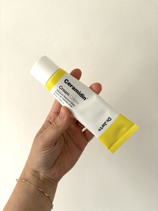 Mica Ricketts holding tube of Dr. Jart+ Ceramidin Cream